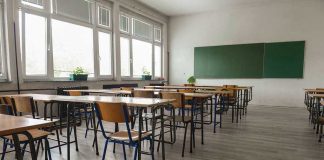 Democrat BRAINWASHING Scheme Uncovered – Infiltrated Schools! Empty classroom with desks, chairs, windows, and chalkboard.