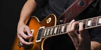 Rock Legend DEAD – Band Members Distraught Hands playing an electric guitar.