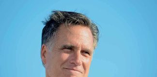 Tragedy Strikes Romney Family – DEVASTATING! A smiling man in a casual shirt against a clear blue sky