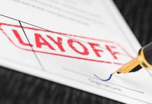 Massive Layoff Storm Hits Media Corp – Thousands Cut! Close-up of a layoff notice with a signature line and a fountain pen