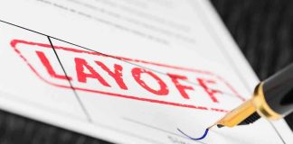 Massive Layoff Storm Hits Media Corp – Thousands Cut! Close-up of a layoff notice with a signature line and a fountain pen