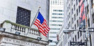 UNEXPECTED Inflation Collapse Triggers Market Frenzy Facade of the New York Stock Exchange with an American flag and Wall Street sign