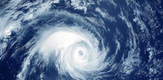 Tropical Storm CATASTROPHE – 500+ Dead, Millions Homeless Satellite image of a swirling hurricane over ocean.