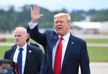 Trump CUTS Loose His Biggest Ally – Has Perfect Send-Off Man in suit waving while another man stands nearby.