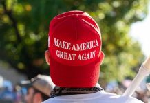MAGA Labeled Racist – Professor FIRED Instantly Person wearing a red Make America Great Again hat.