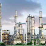 Toxic LEAK DEVASTATES Town — Dozens Hospitalized! Industrial plant with metal towers and pipes.