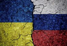 Ukraine BOMBS Moscow – Putin Scrambles! Cracked Ukrainian and Russian flags painted on concrete.