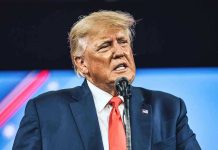 Trump CANCELS ALL Biden Orders – Draws Redline! Man in suit speaking at a microphone.