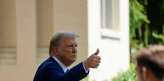 Trump PLEDGES $2,000 for All—But At What Cost? Man in suit giving thumbs up.