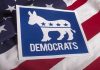 JFK Grandson’s OUTRAGEOUS Discrimination Scheme Uncovered Democrats logo on American flag background