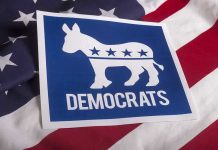 JFK Grandson’s OUTRAGEOUS Discrimination Scheme Uncovered Democrats logo on American flag background