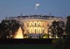 The White House illuminated at night with a fountain in the foreground