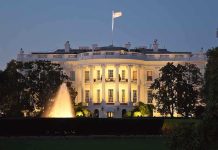 Guardsmen GUNNED DOWN Blocks From White House The White House illuminated at night with a fountain in the foreground
