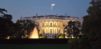 Guardsmen GUNNED DOWN Blocks From White House The White House illuminated at night with a fountain in the foreground