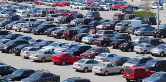 A crowded parking lot filled with various cars