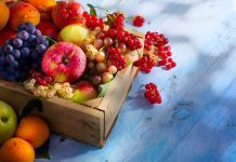 Apple vs. Pumpkin Pie: The Blood Sugar Battle A wooden crate filled with a variety of fresh fruits including apples grapes and berries