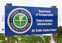 FAA Slashes Flights—Airports Spiral Into Turmoil Sign for the Federal Aviation Administration at an air traffic control tower