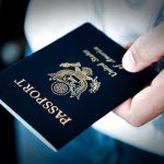 Supreme Court Passport Bombshell—Chaos for Travelers A person holding a United States passport with a dark background