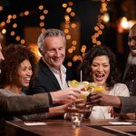 Think You’re Sober? Alcohol Detection Says Otherwise People laughing while clinking glasses at a bar