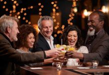 Think You’re Sober? Alcohol Detection Says Otherwise People laughing while clinking glasses at a bar