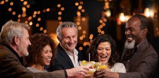 Think You’re Sober? Alcohol Detection Says Otherwise People laughing while clinking glasses at a bar