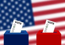 Ballots in boxes with American flag background.