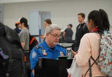 Violent Assault SHOCKS Airport – TSA Agent Attacked, Officer STABBED! TSA agent checks passengers documents at airport security.