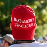 SHOCKING Poll Reveals Trump Base Rebellion Person wearing a red Make America Great Again hat.