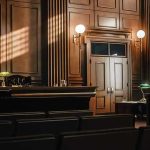 Empty courtroom with judges bench and wooden decor.