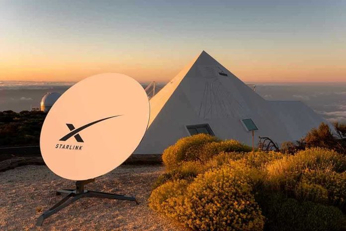 2133739611 Satellite dish near pyramid-shaped building at sunset.