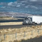 Undocumented Truckers CRACKDOWN — 87 Arrests Truck driving on rural highway near river and mountains