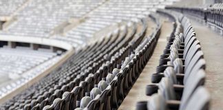 Iconic Sports Stadium DESTROYED – 145 Years Gone! Empty rows of gray seats in a stadium.