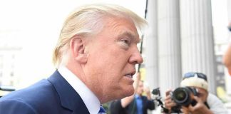 Trump DOZES During Peace Ceremony – Biden 2.0? Man in suit with photographers in background.