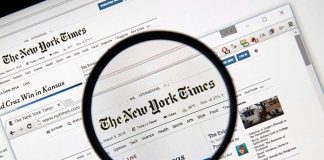 Magnifying glass over The New York Times website.