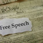 Old document with text Free Speech overlay