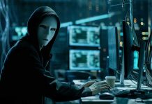 AI Hackers Outpace Humans — Nightmare Scenario Looms Person wearing mask and hoodie at computer desk.