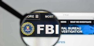 FBI Issues ALERT – Terrifying New Kidnapping Trend FBI website shown through magnifying glass.