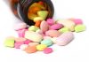 750 Daily Hospitalizations: The Hidden Pill Problem A variety of colorful pills and tablets spilled from a brown medicine bottle