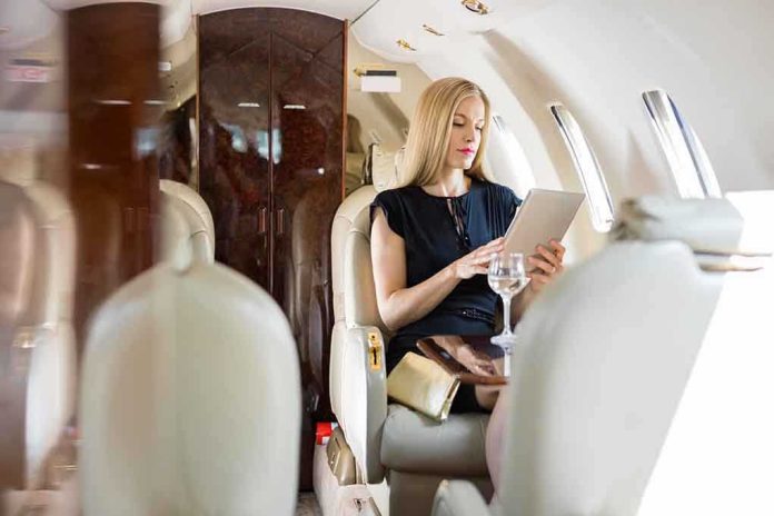 shutterstock_167757638.jpg A woman in a private jet using a tablet while seated elegantly