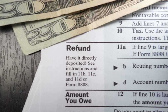 Close-up of tax refund form with cash on a wooden surface