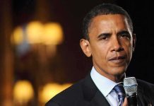 Obamas TOP Chief ARRESTED – Faces Federal Charges! Individual speaking into a microphone at an event