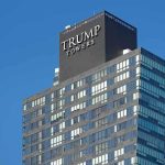 View of Trump Towers, a modern skyscraper with a glass facade against a clear blue sky