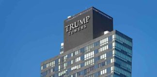 View of Trump Towers, a modern skyscraper with a glass facade against a clear blue sky