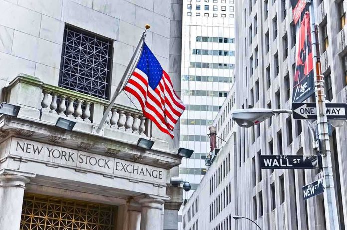 Facade of the New York Stock Exchange with an American flag and Wall Street sign