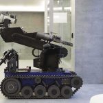 Robots Take Over Battlefield: Humans Out of Harm’s Way A robotic arm mounted on a tracked base in a modern workspace