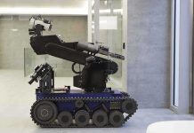 Robots Take Over Battlefield: Humans Out of Harm’s Way A robotic arm mounted on a tracked base in a modern workspace