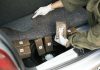 Washington’s Drug War—A Cover for Control? Person discovering wrapped packages in a car trunk.