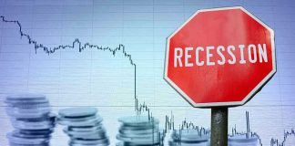 Recession sign, coin stacks, downward stock chart background.