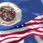 2,000 Agents SWARM Minneapolis — Tensions Soar Minnesota state flag with American flag in background.