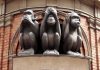 AI Hoax SABOTAGES Police Monkey Hunt Three wise monkeys statue on a brick building.